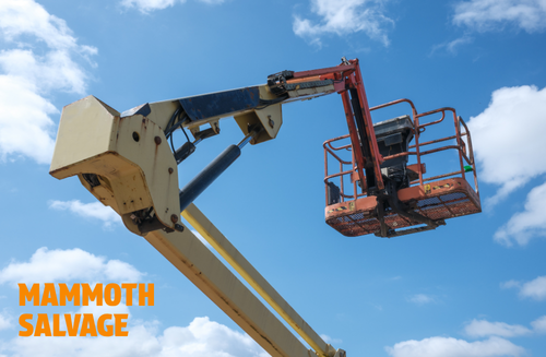Photo of a yellow and orange cherry picker with a graphical overlay of text saying MAMMOTH SALVAGE
