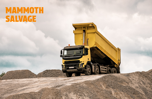 Photo of a yellow dump truck with a graphical overlay of text saying MAMMOTH SALVAGE