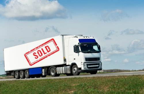 Photo of an HGV with a red sold label on the side