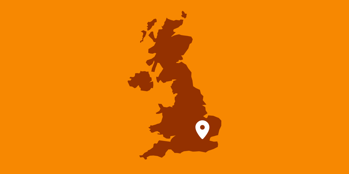 Graphic of a brown UK map and a white map marker over London with an orange background
